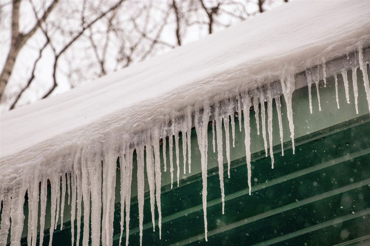 Row of icicles hanging off a gutter after a freeze