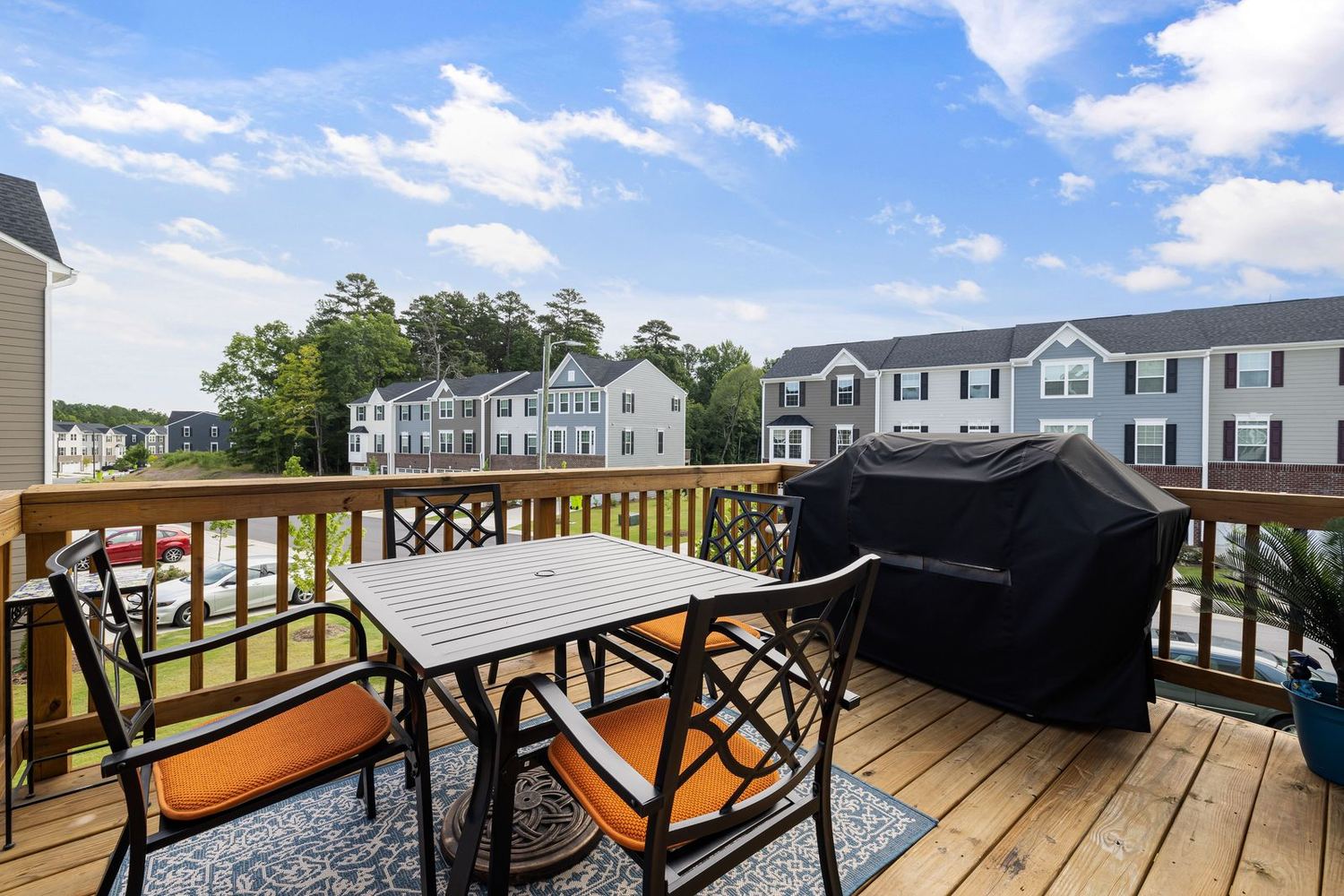 Composite deck with furniture, rail, and a view of the neighborhood