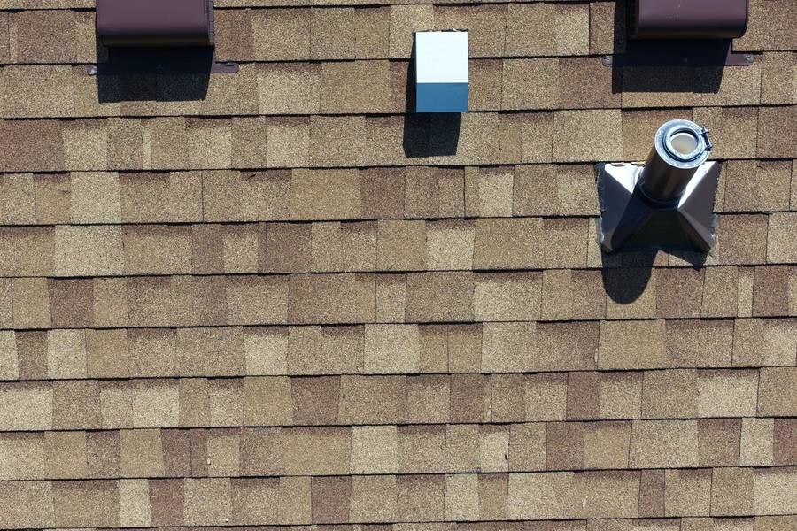 New asphalt shingle roof with clean vent and pipe flashings
